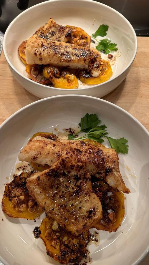 Two plated dishes with a chili glaze and herbs