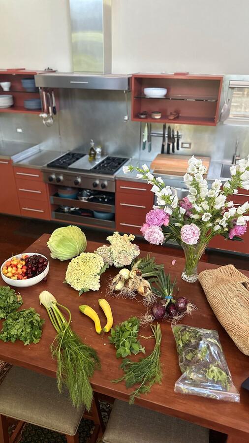 Produce and flowers spread across the kitchen island