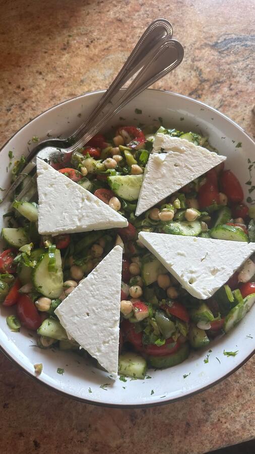 A chopped salad topped with triangles of feta