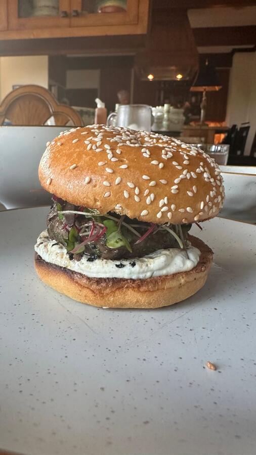 A burger on a sesame bun