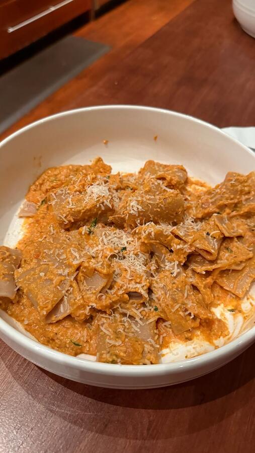 A bowl of pasta with shaved cheese