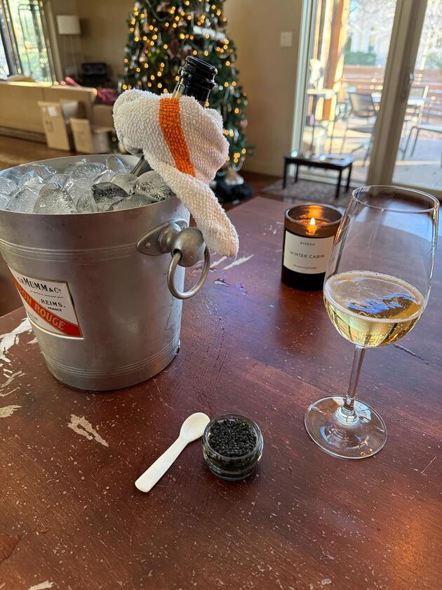 Champagne and caviar on a wooden table