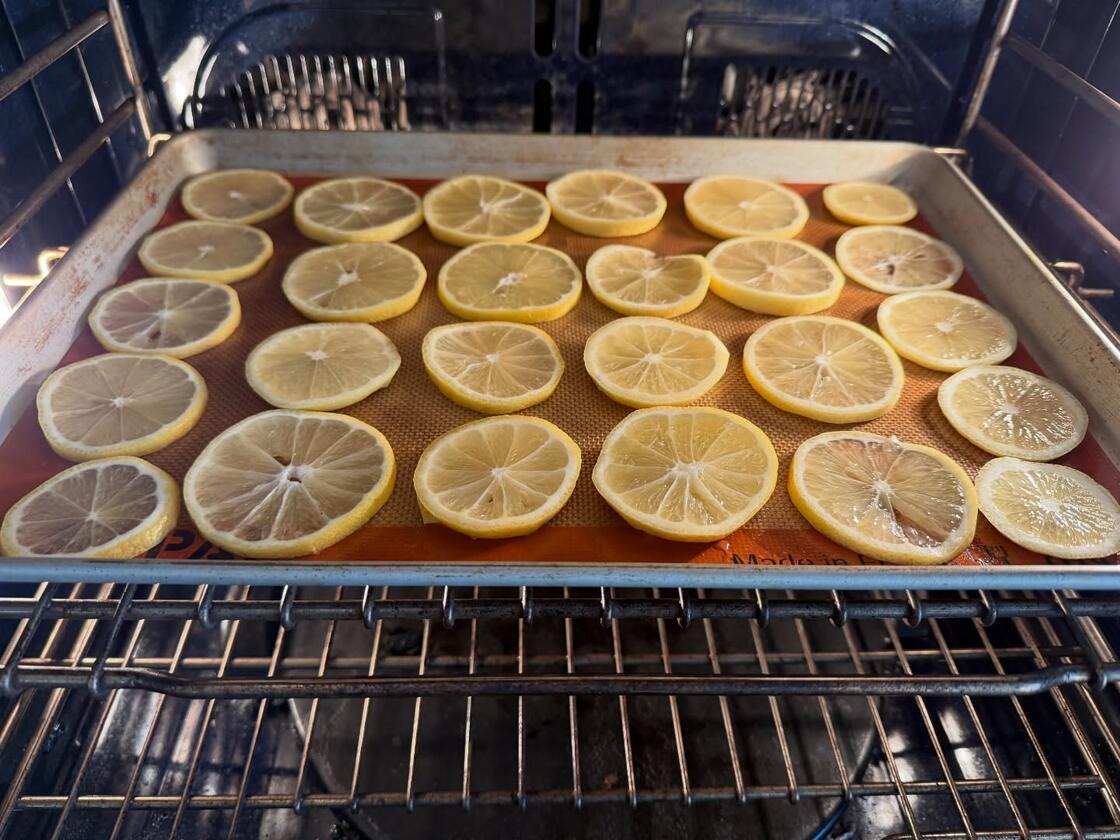 Lemon slices drying on an oven rack