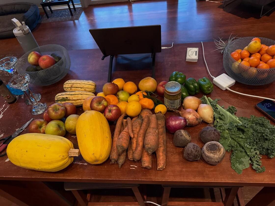 A farmers market produce haul spread across the kitchen table