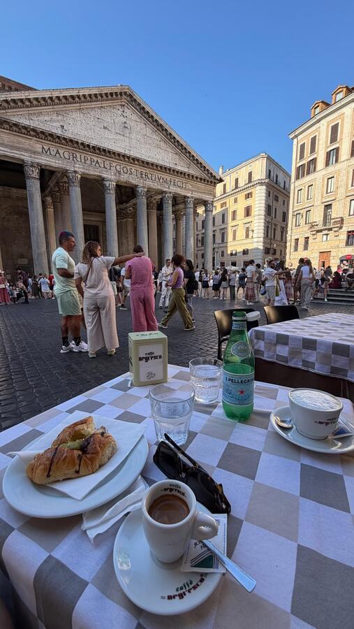 A cafe table with the Pantheon behind it