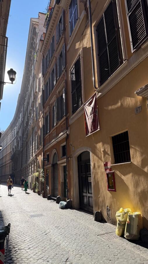 A narrow Roman street hung with flags